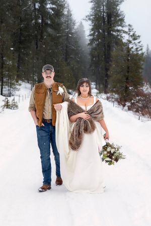 Portrait of bride and groom full body serious faces snowy winter elopement in Idaho City