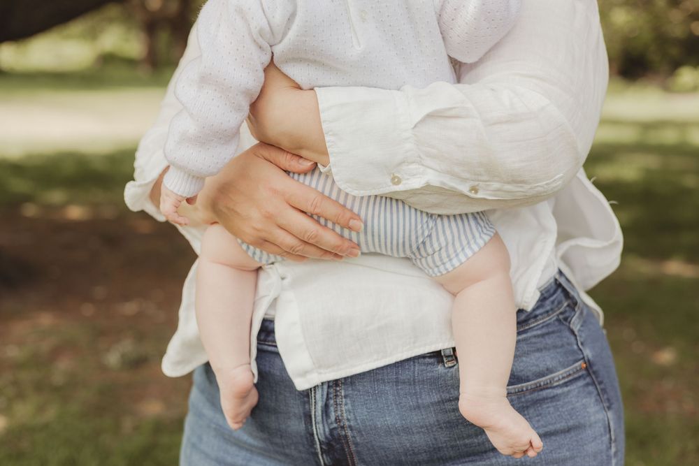 mum holding baby boy - outdoor on Wandsworth common