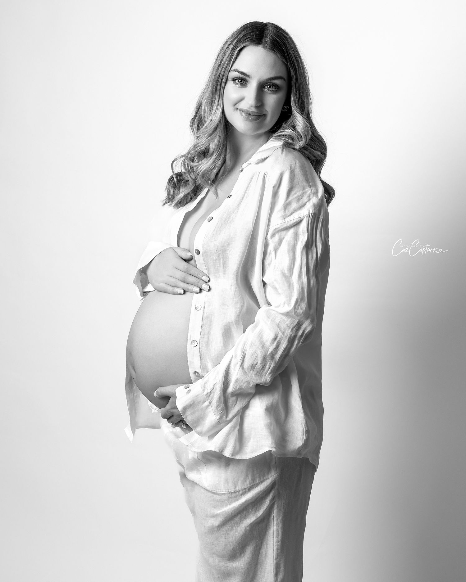 White linen shirt and pants set for a relaxed yet elegant black and white studio maternity session.