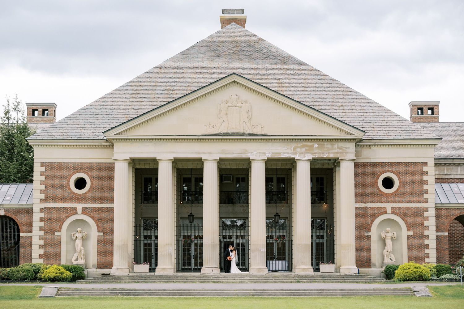 Bride and groom portraits at the columns outside of the historic Hall of Springs in Saratoga Springs, New York.