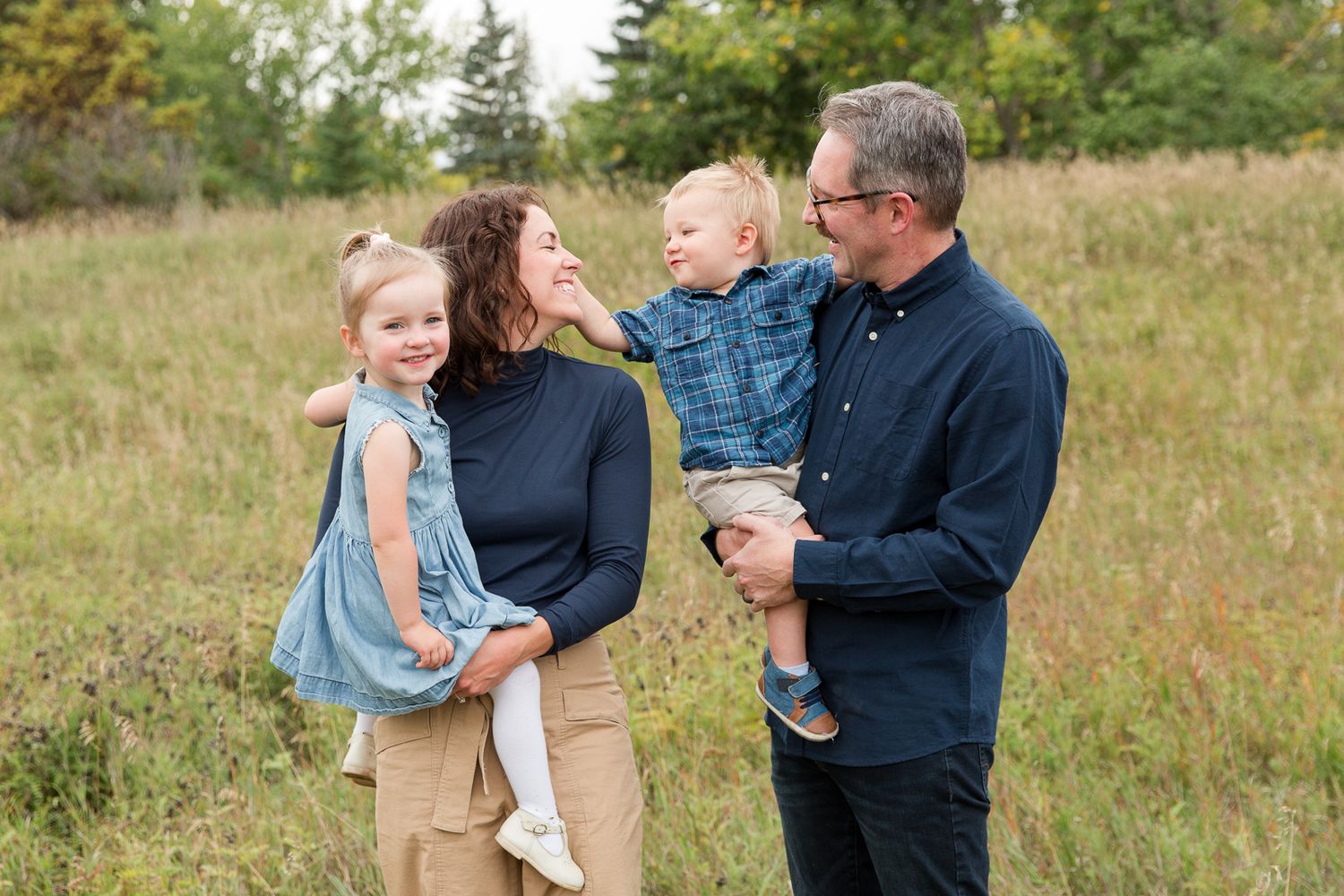 Happy group shares joyful moment together outdoors in an autumn field.