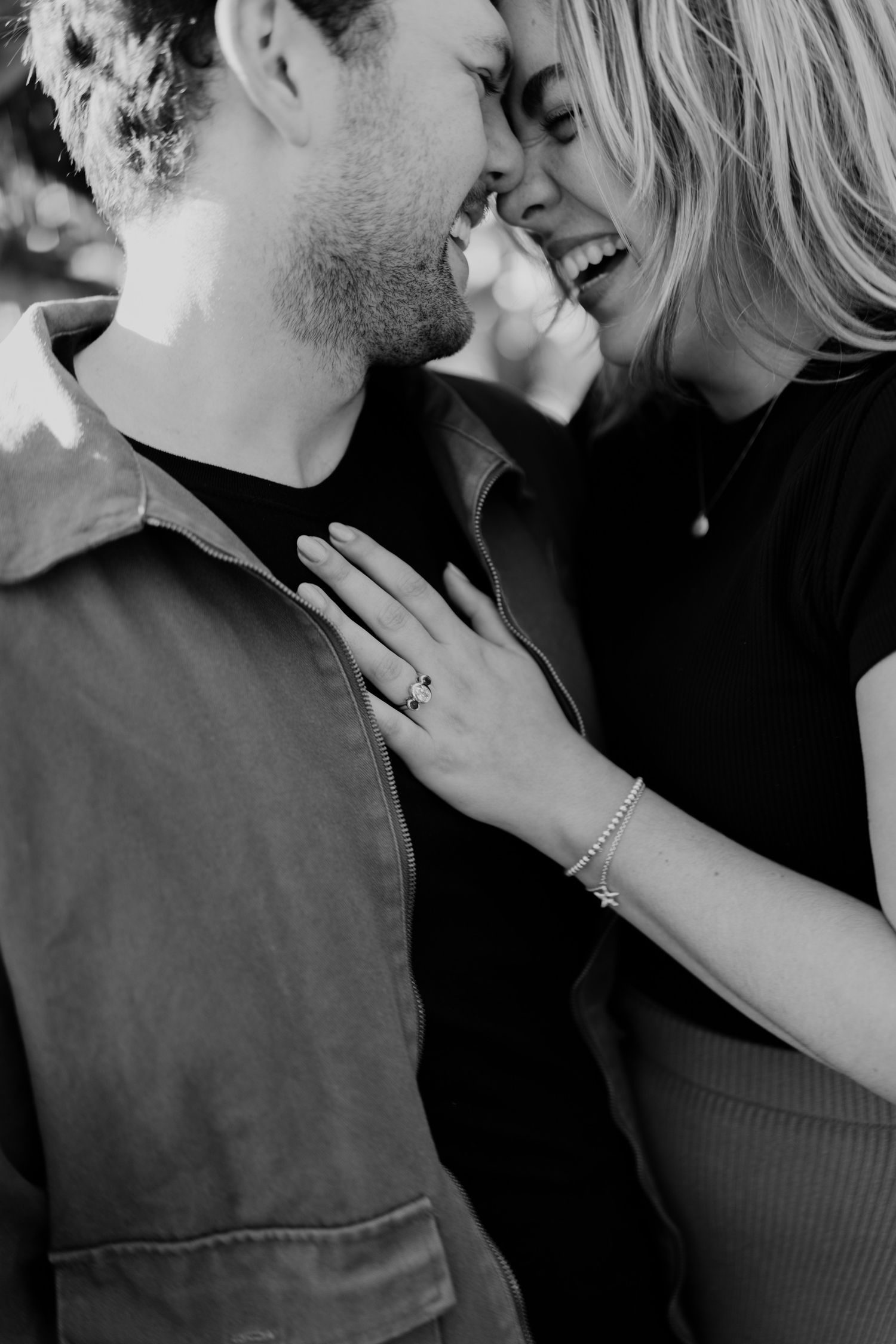 Close-up intimate black and white photo showing tender romantic moment between couple.