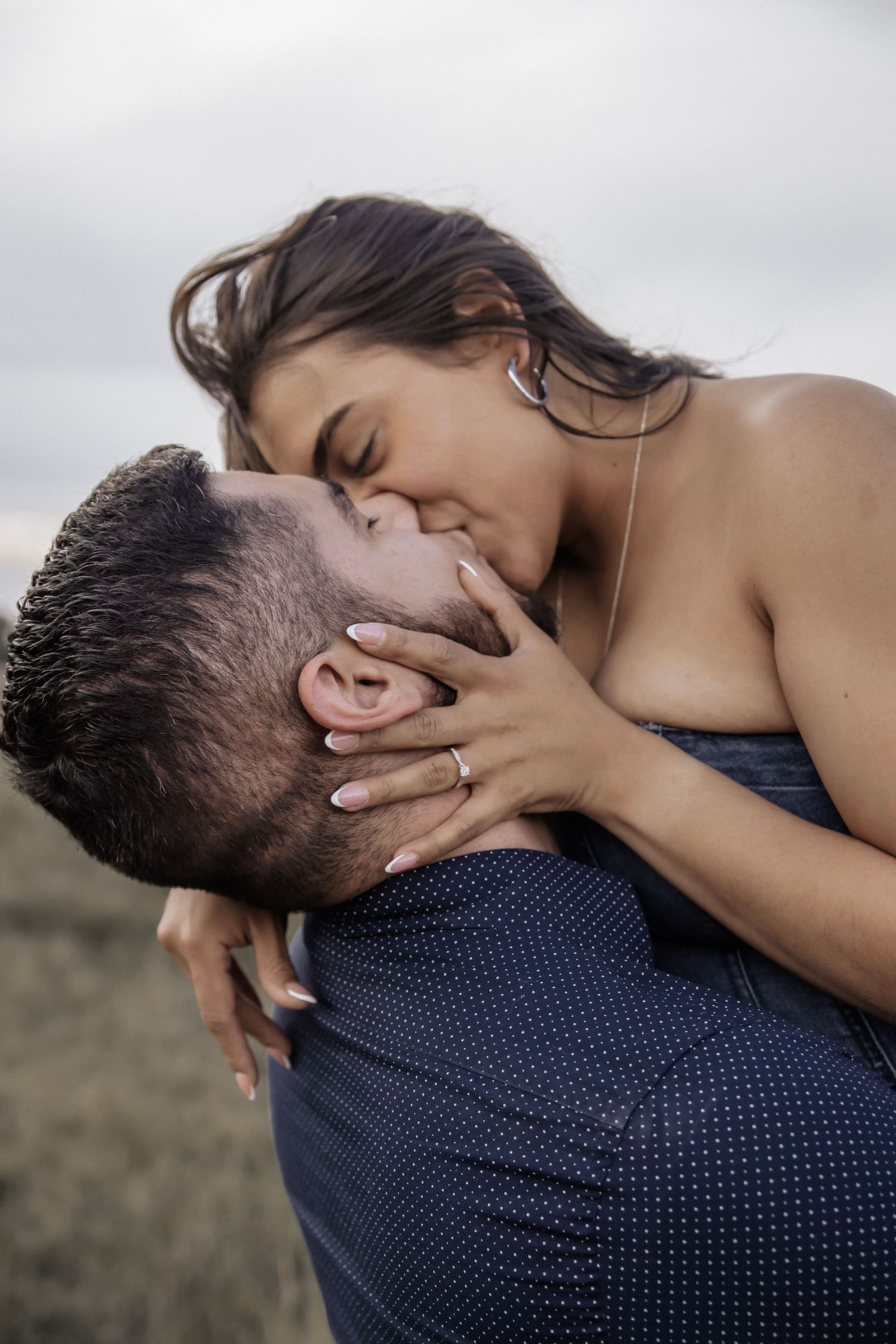 Couple shares a kiss while woman is being lifted in the air