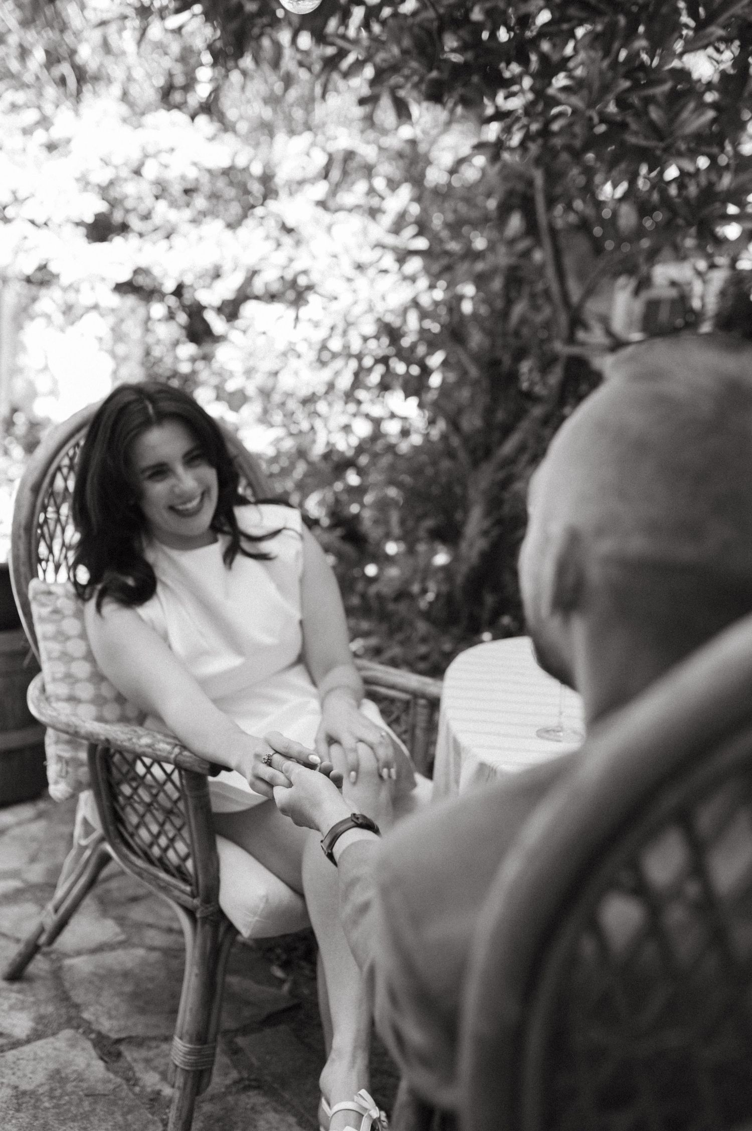 A happy couple sharing an intimate moment in a garden setting.