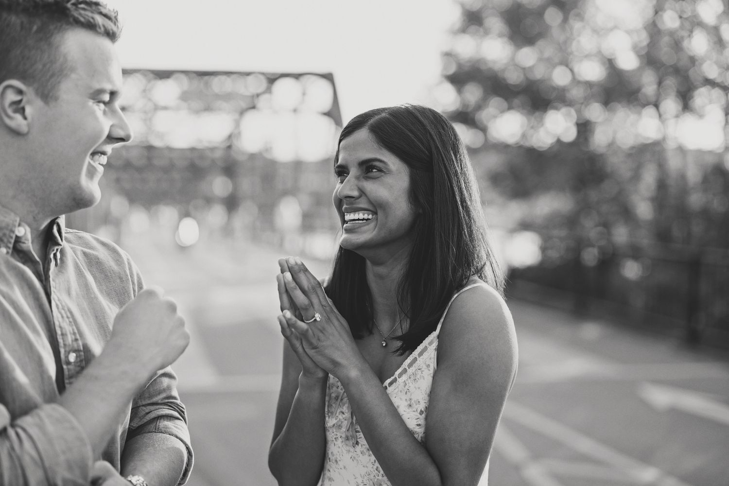 Black and white photo of a joyful couple sharing a tender moment after an outdoor marriage proposal. Photo by Laura Leigh Images.