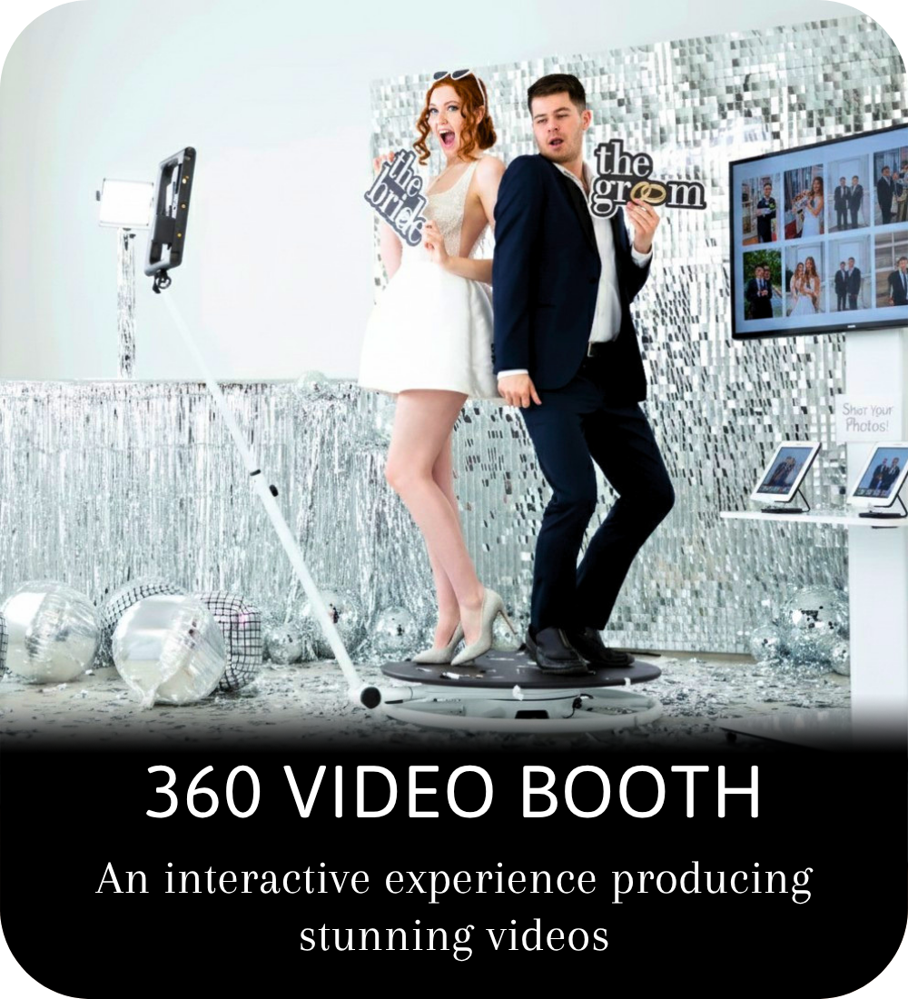 Two women posing in a print photo booth, one holding a red phone, with text reading Print Booth below.