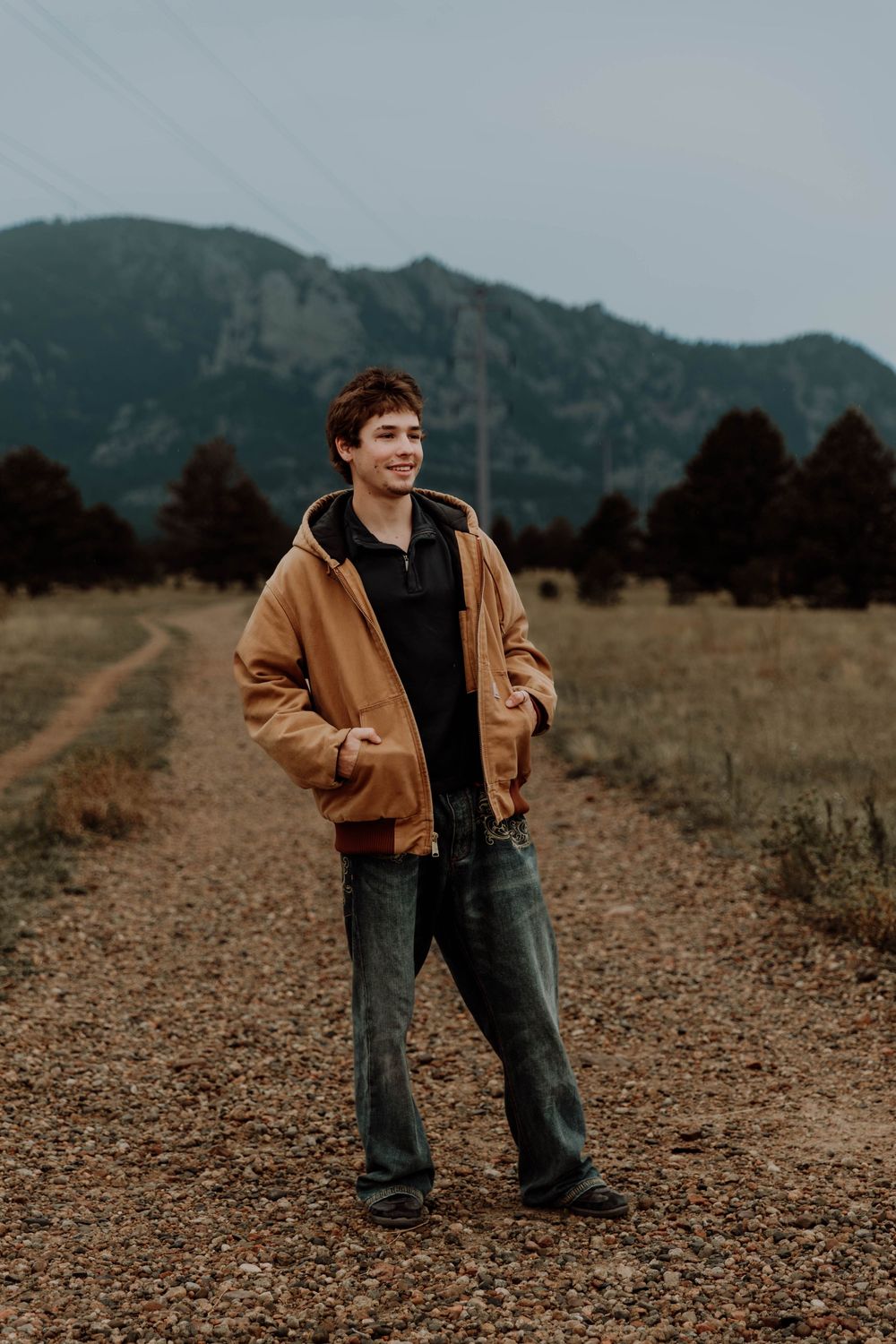 Boy stands, and poses for senior photos, cinematic, mountain, and portrait photos in Boulder, Colorado outside and in nature