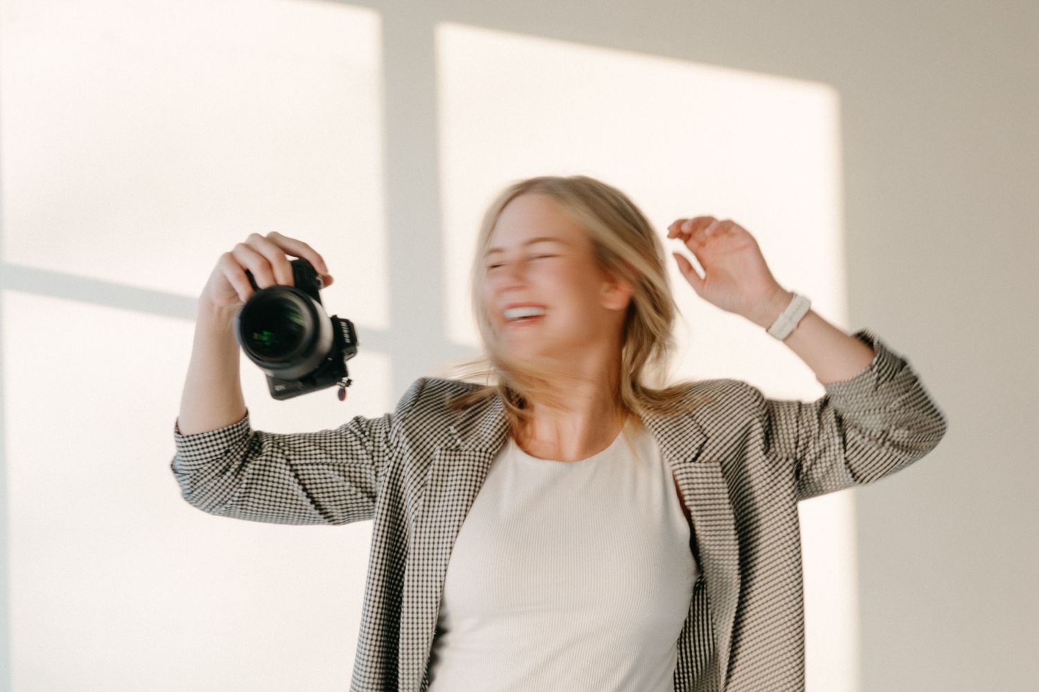 Photographer smiling and having fun in the studio during a personal branding session.