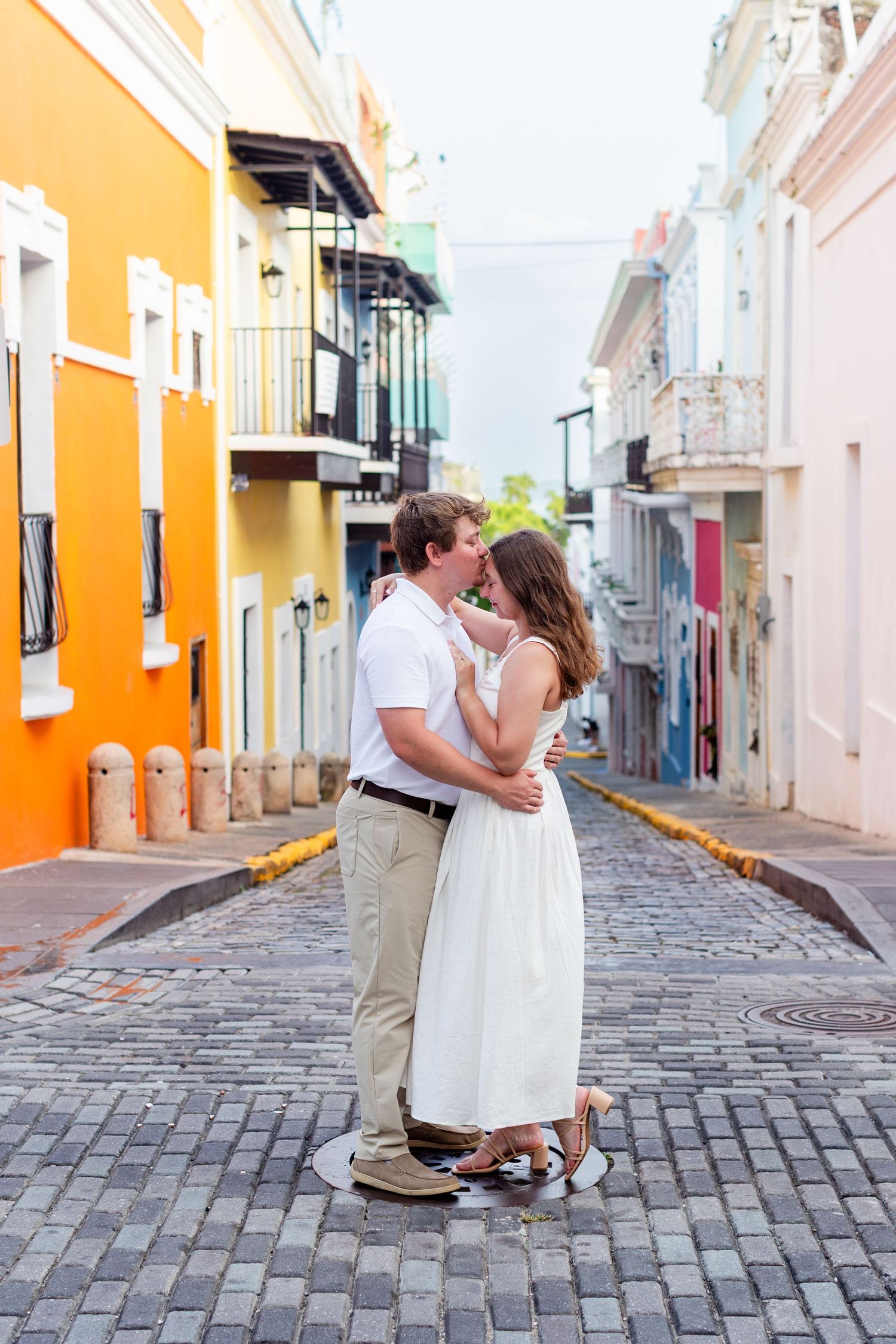 Couple posing in the middle of the street. Engagement photo session in Old San Juan, Puerto Rico.
