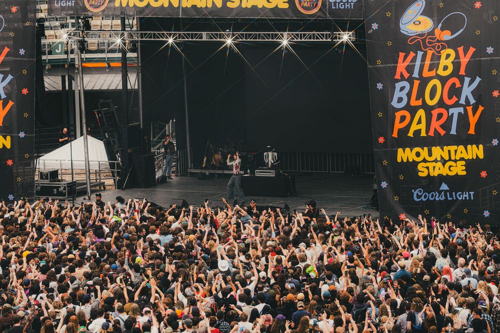 Performers on stage at Kilby Block Party Mountain Stage with a massive crowd and Coors Light branding.