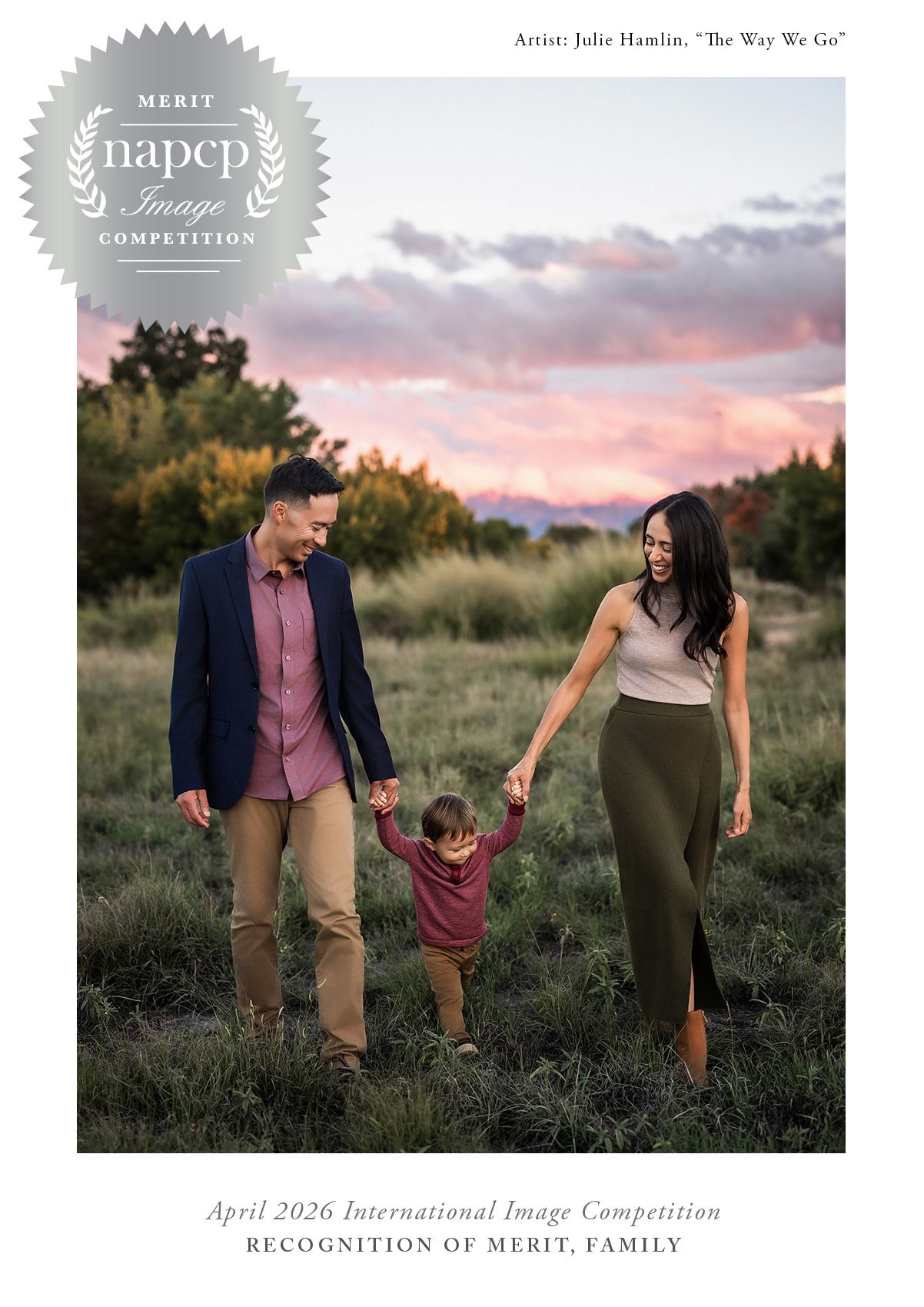 Award-winning family portrait of parents and toddler walking at sunset in a field, NAPCP Merit Image Competition winner.