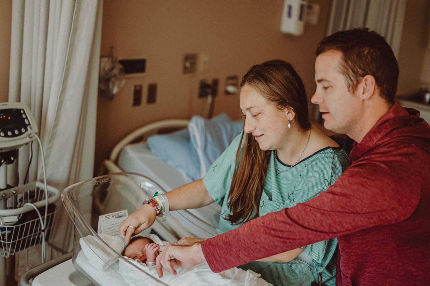 Parents reviewing medical information in hospital room.