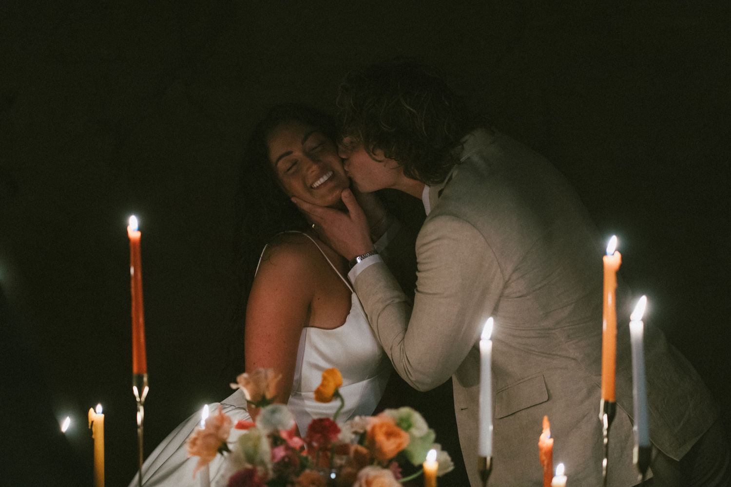 Candlelit table setting creates intimate atmosphere at nighttime celebration.