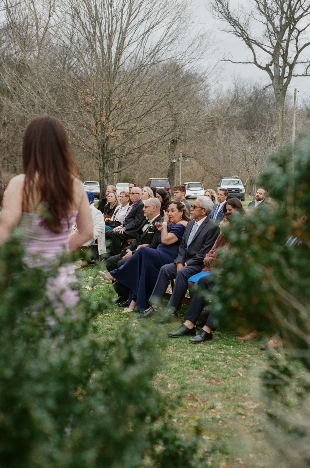 Mother of groom wipes away tear during ceremony