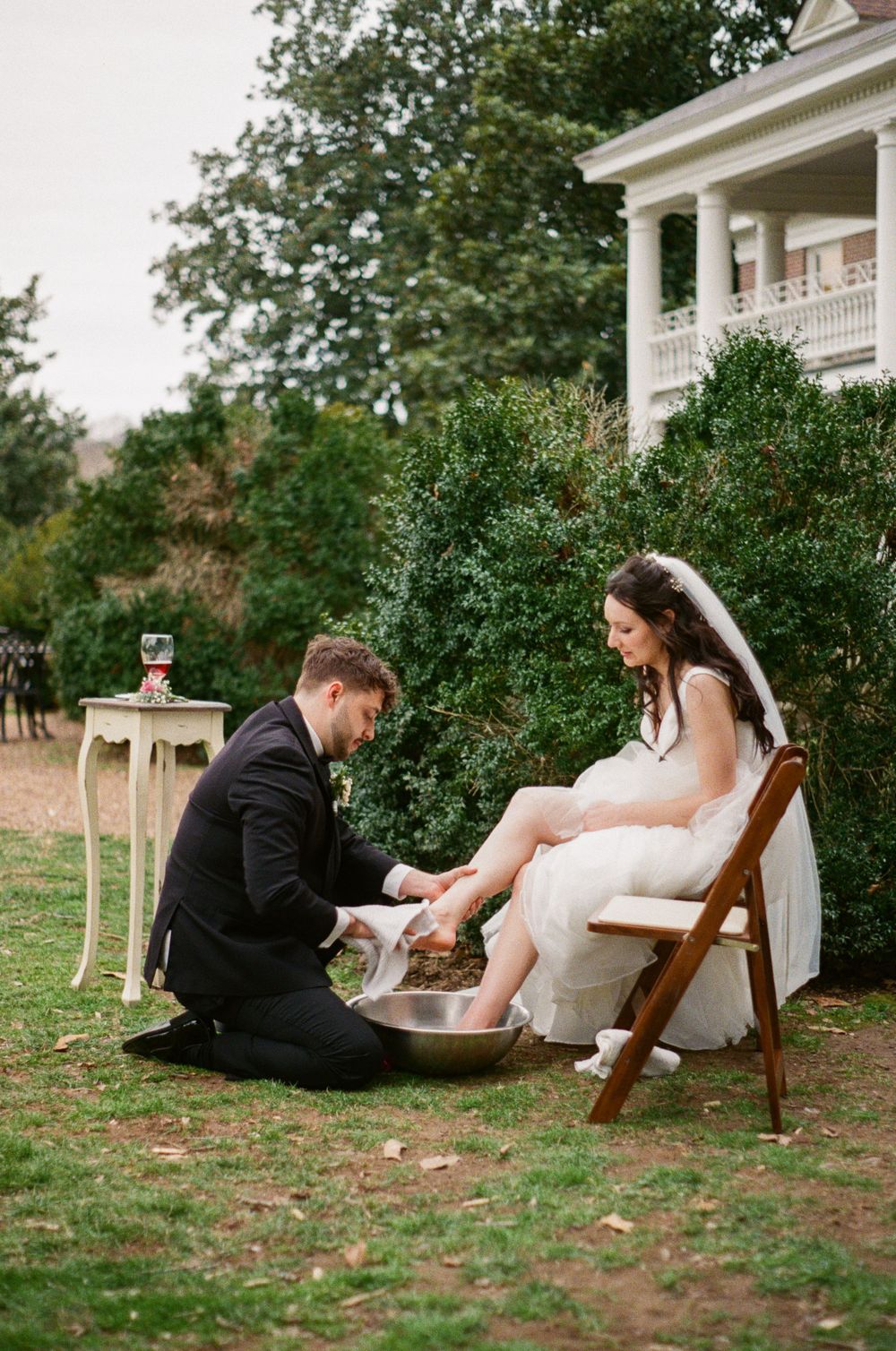 Groom washes bride's feet during ceremony