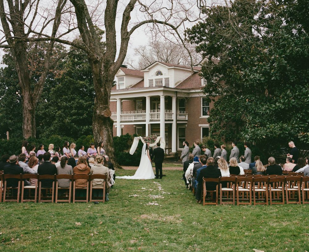 Medium format film image of wedding ceremony on lawn of historic mansion