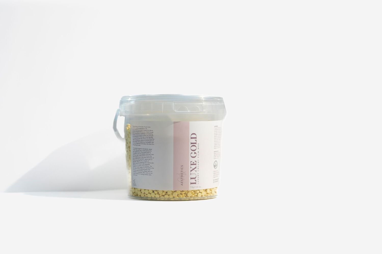 White plastic container with some granular ingredients on a minimalist white background.