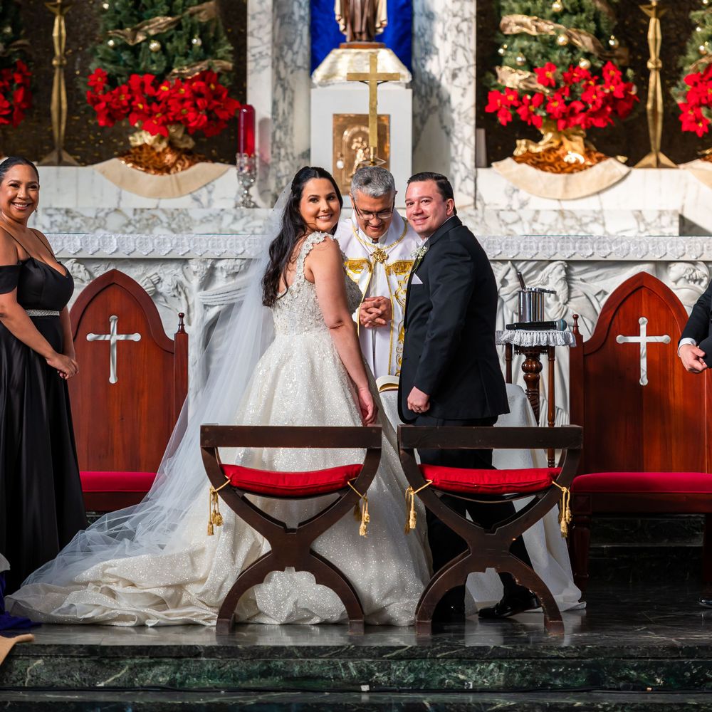Wedding ceremony at decorated church altar with Christmas trees and poinsettias.