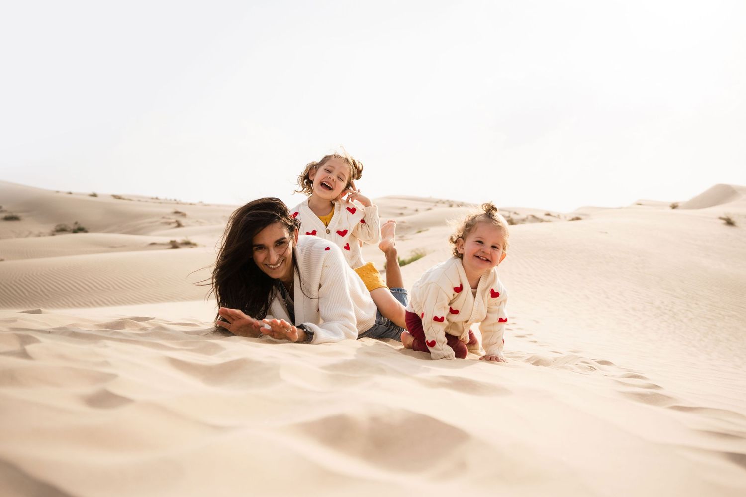 family maternity photoshoot at the desert beach natural light golden hour in abu dhabi lifestyle al jurf