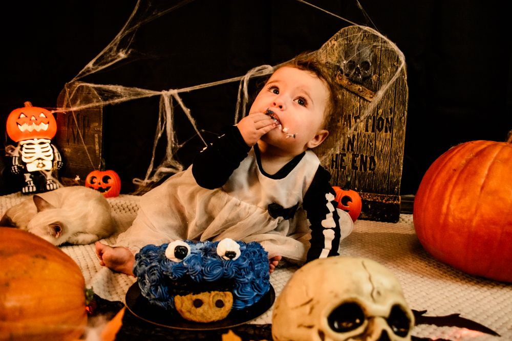 Halloween themed setup with pumpkins, decorative skulls and spooky decorations.