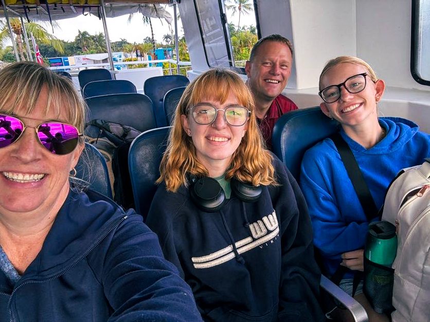 Group enjoying a ride together on a tour bus during a sunny day.