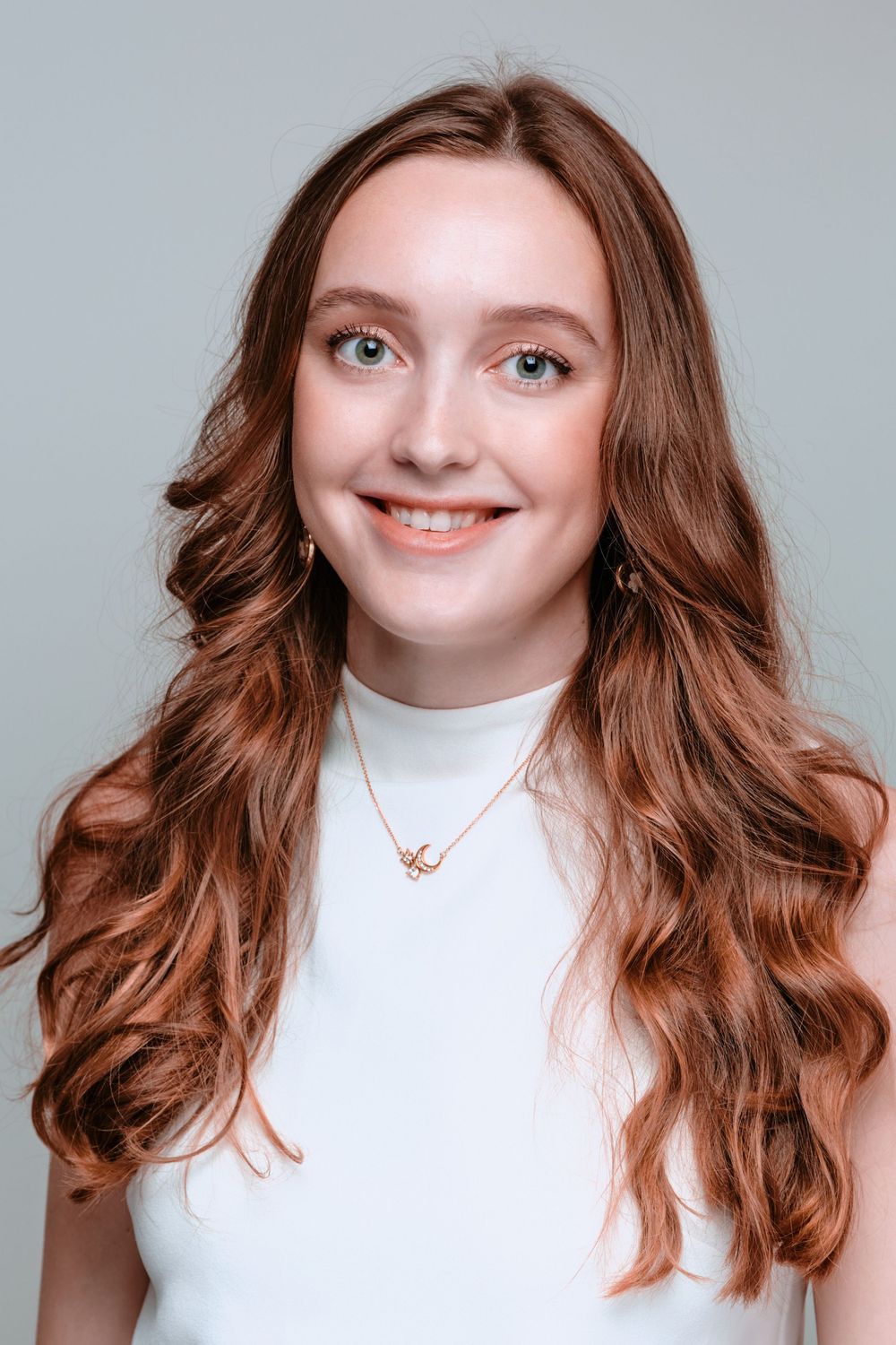 Portrait series showing a person with wavy brown hair against a light gray backdrop wearing a white top.