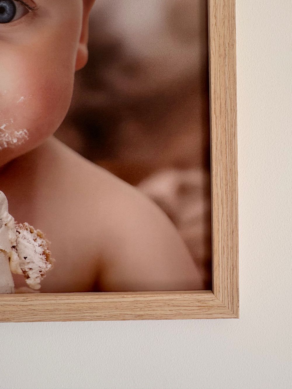 Close-up artistic photo showing a wooden frame corner with sugary sprinkles or powdered substance visible in the frame.