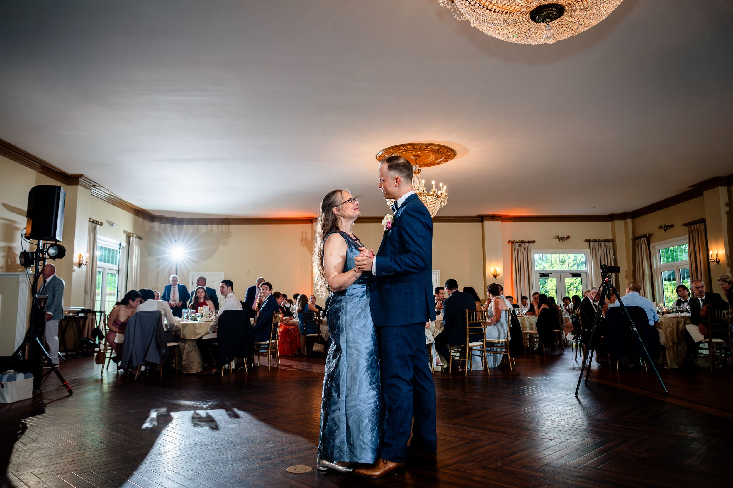 Panoramic view of a wedding reception venue with guests gathered for celebration.