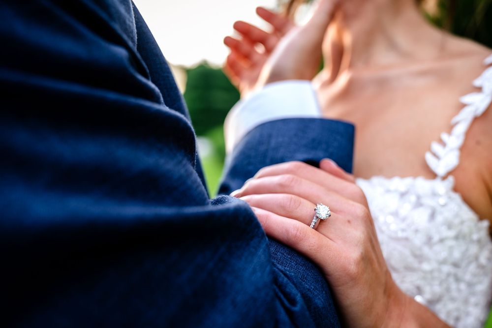 Close-up details of romantic moments during an outdoor wedding celebration.
