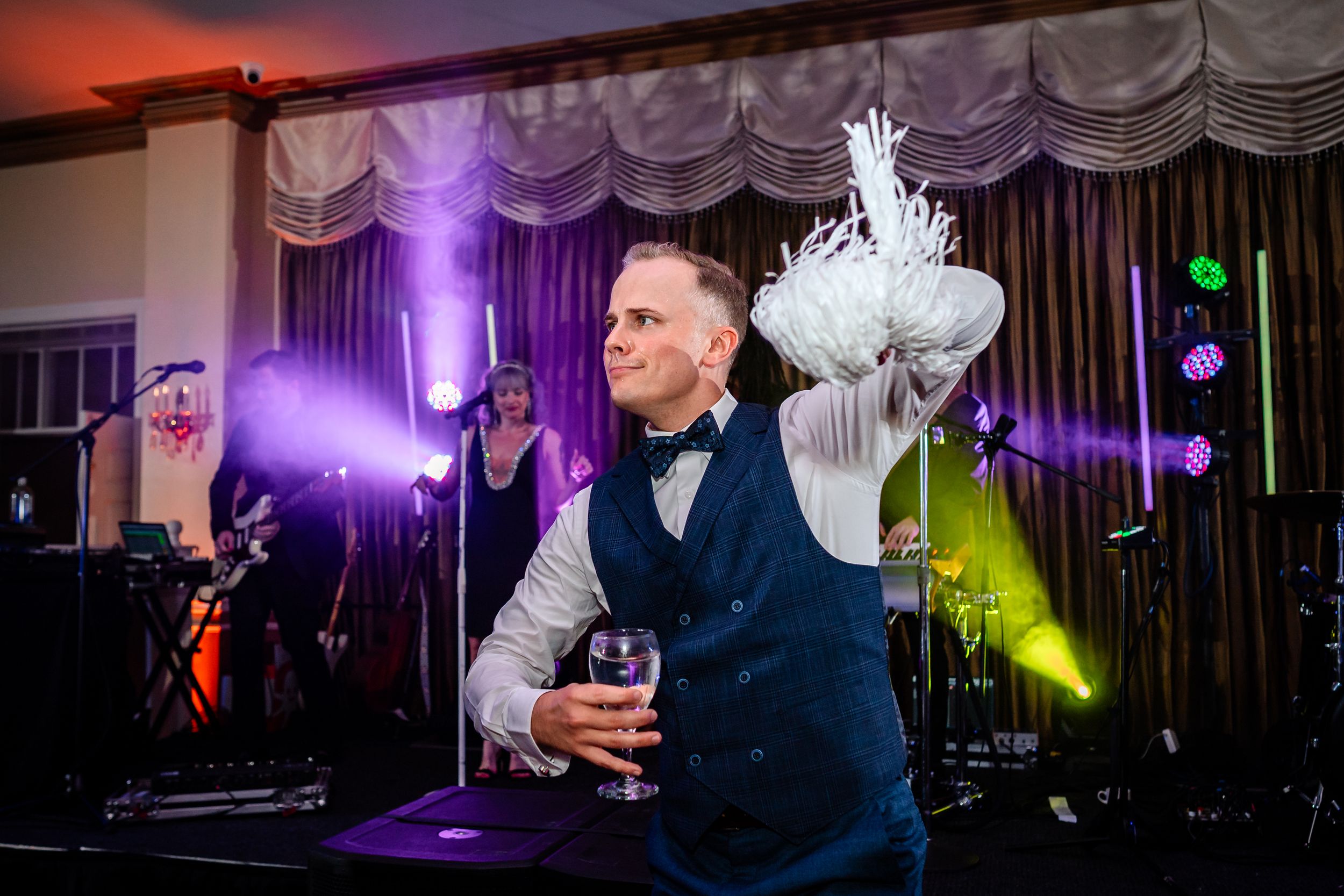 Reception venue decorated with dramatic purple and red lighting effects.