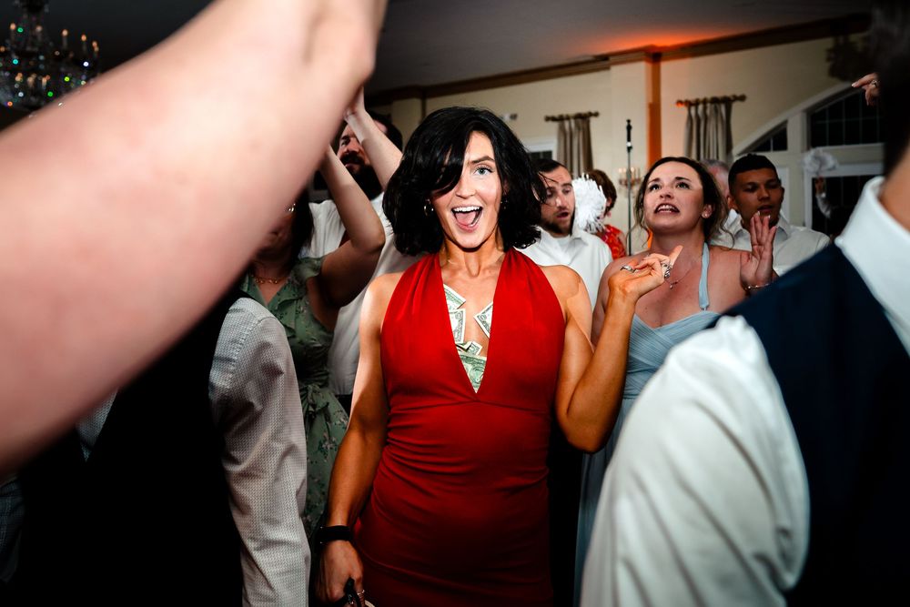 Wedding guests dancing and celebrating during a lively reception party.