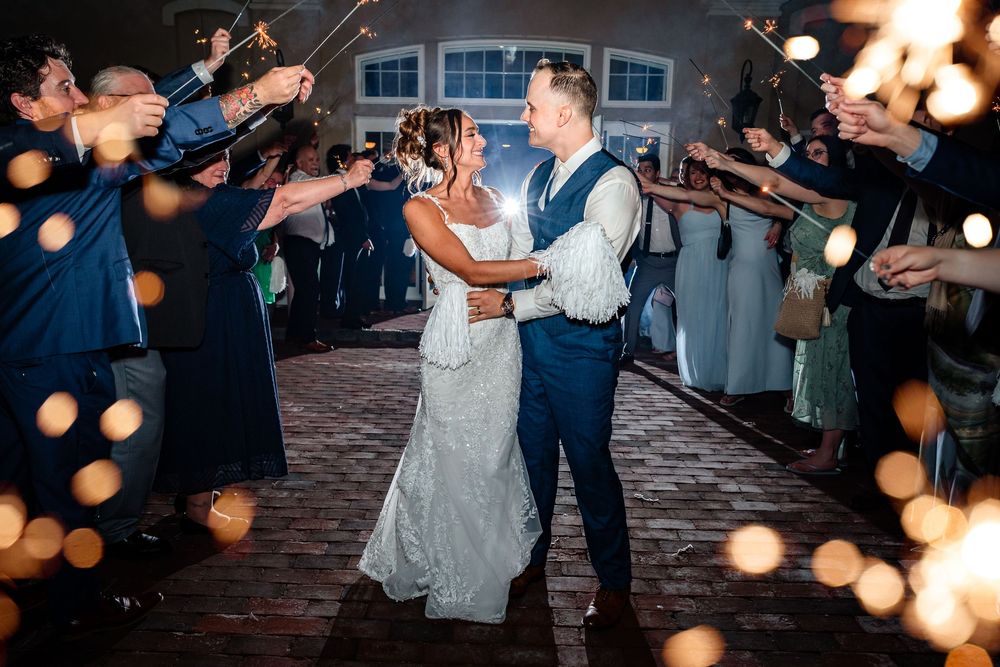 Outdoor evening wedding reception with string lights creating a romantic atmosphere.