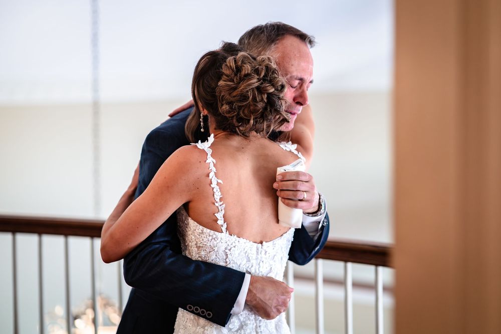An emotional embrace captured during a wedding celebration.