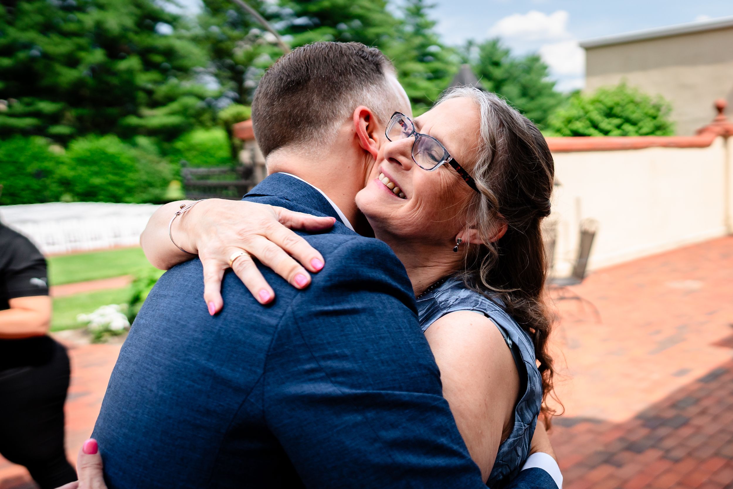 Intimate wedding photography moments captured outdoors on a sunny day.