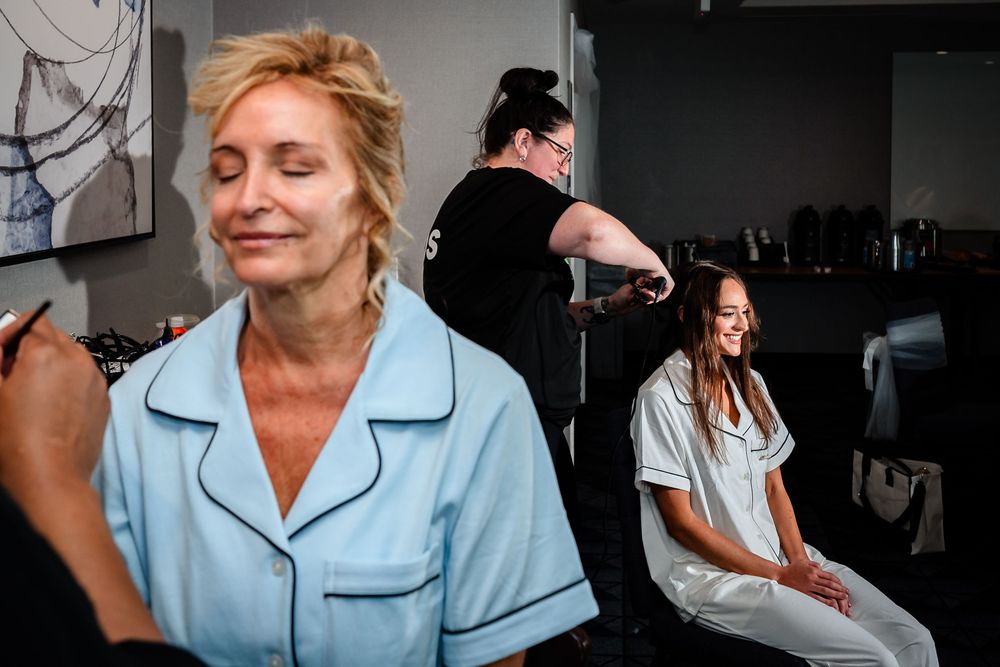 Getting ready scene in soft natural light during wedding preparations.