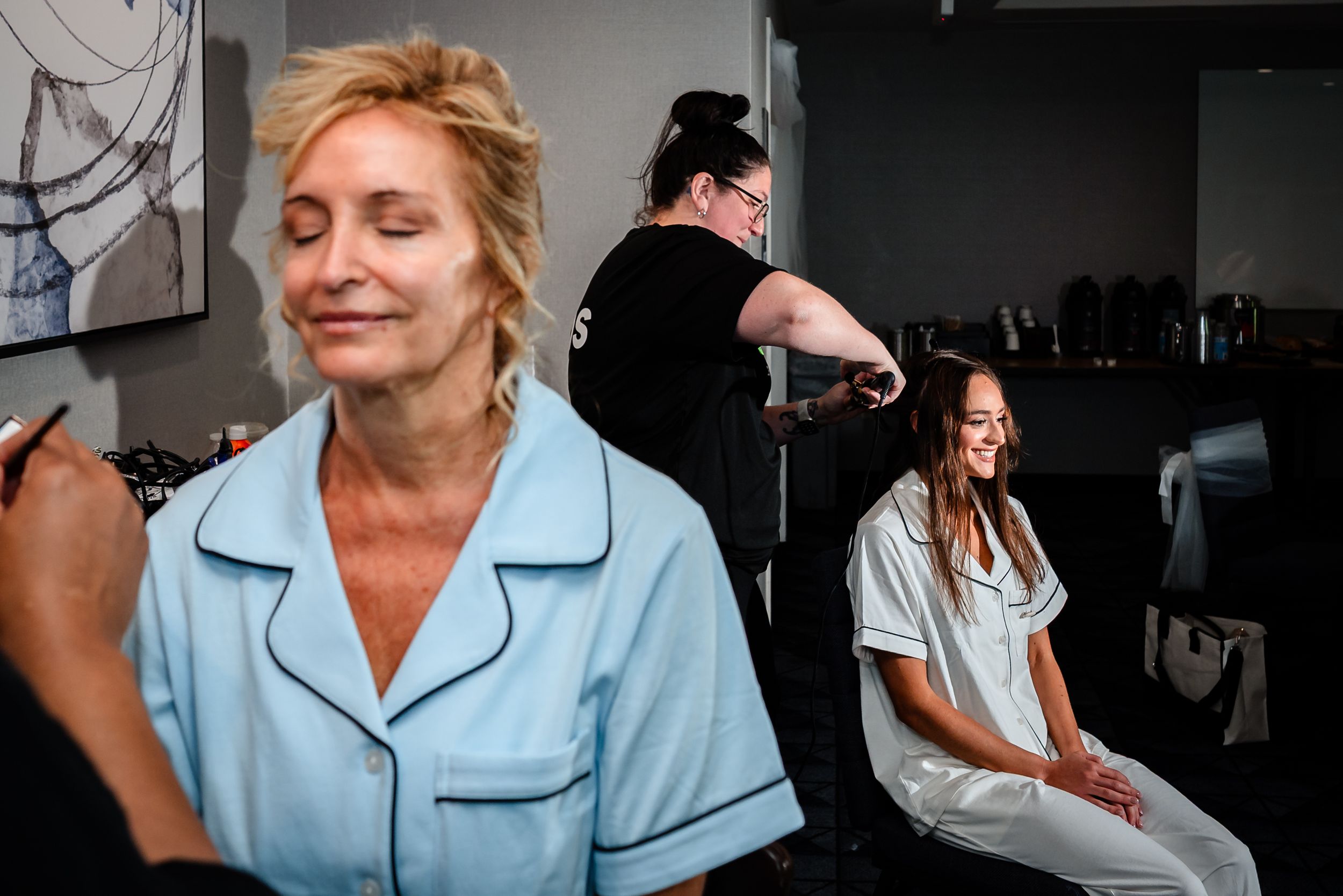 Getting ready scene in soft natural light during wedding preparations.
