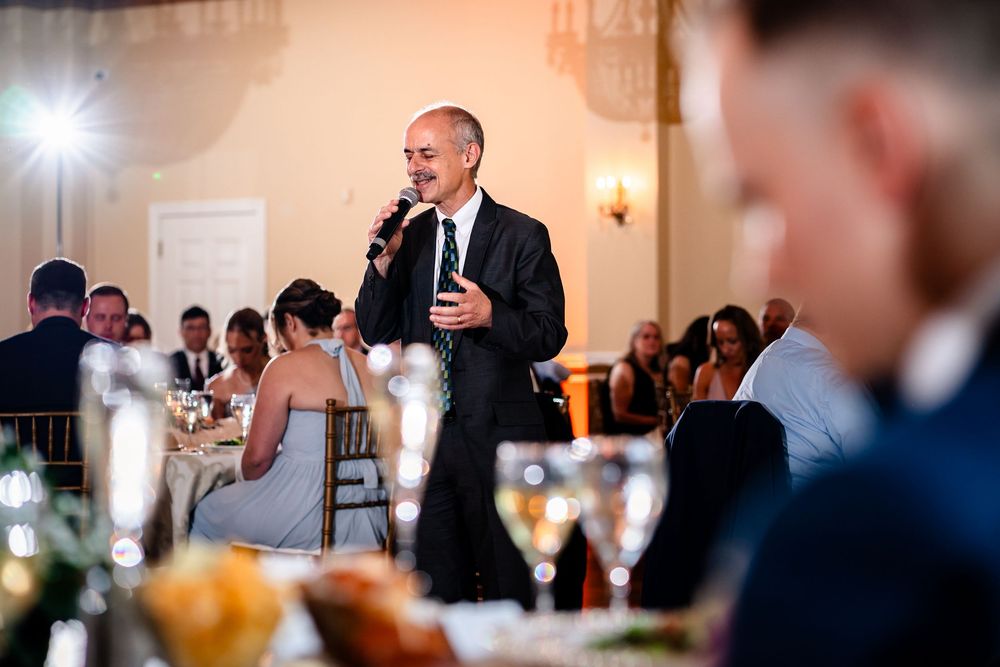 Indoor wedding reception candid moments captured during evening celebrations.