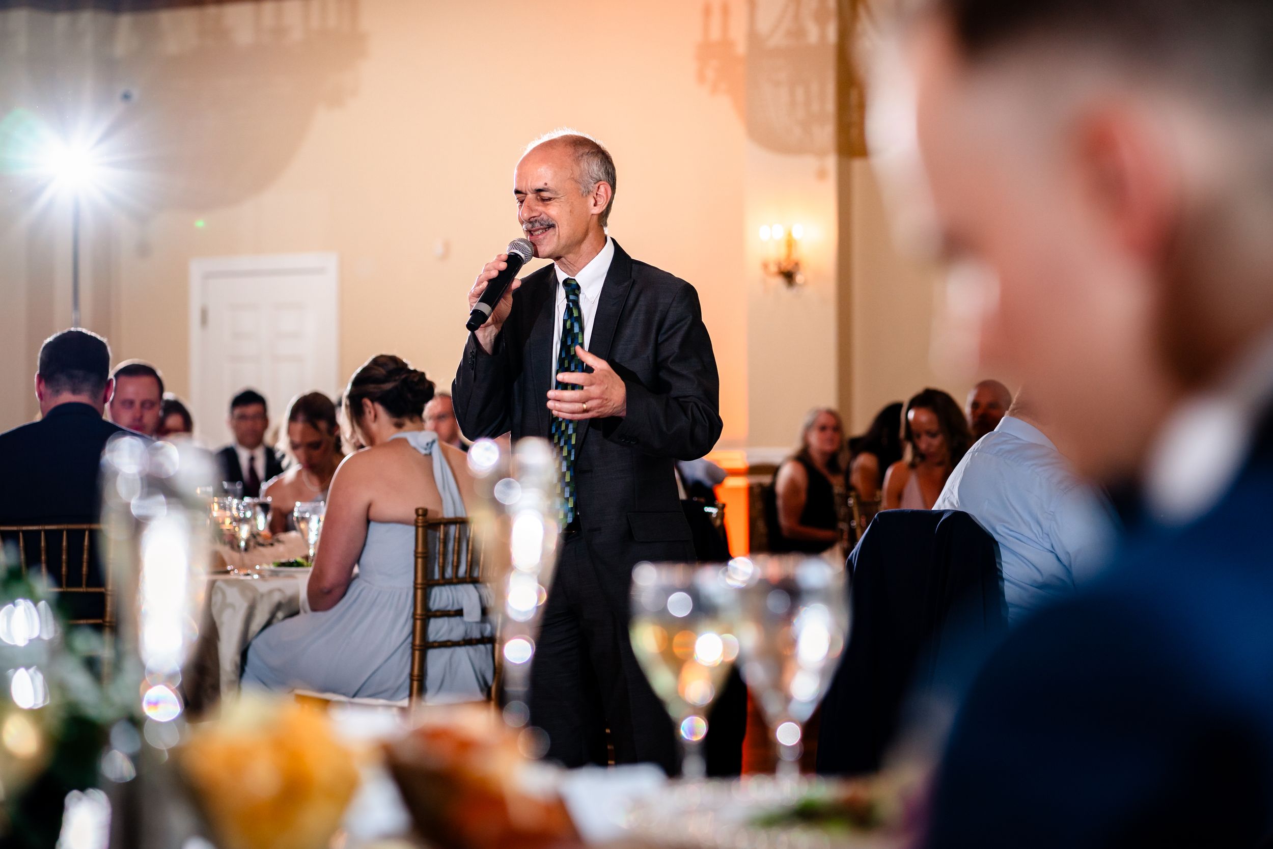 Indoor wedding reception candid moments captured during evening celebrations.
