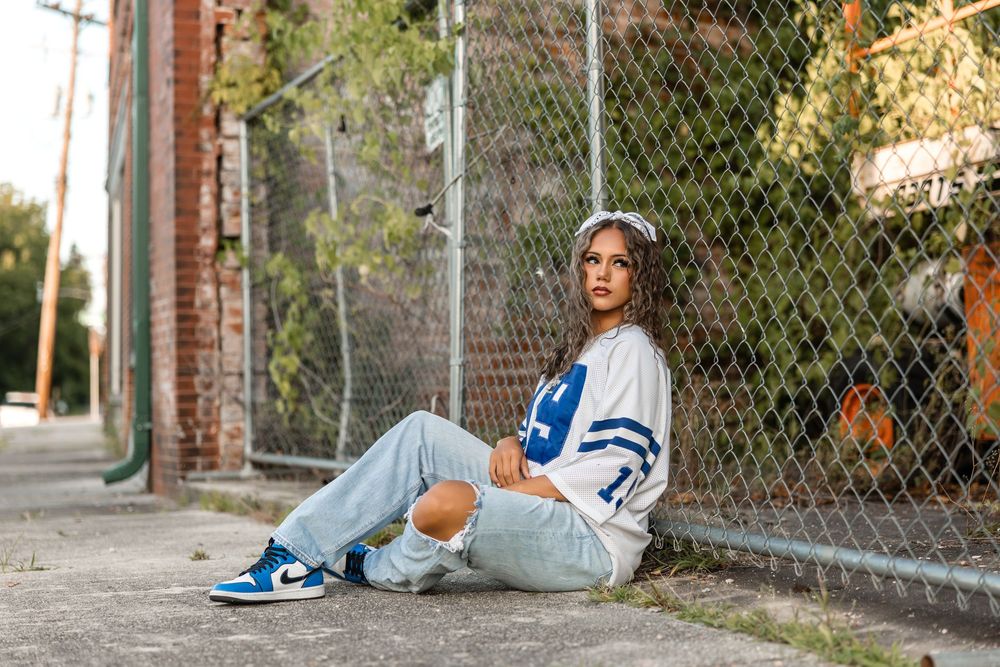 Sequence of photos showing artistic poses against an urban backdrop with chain link fence and brick walls.
