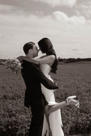 Black and white wedding portraits capturing intimate moments in a rural setting.