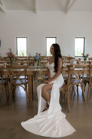 Elegant bridal portraits showcasing flowing white wedding dress in reception venue.