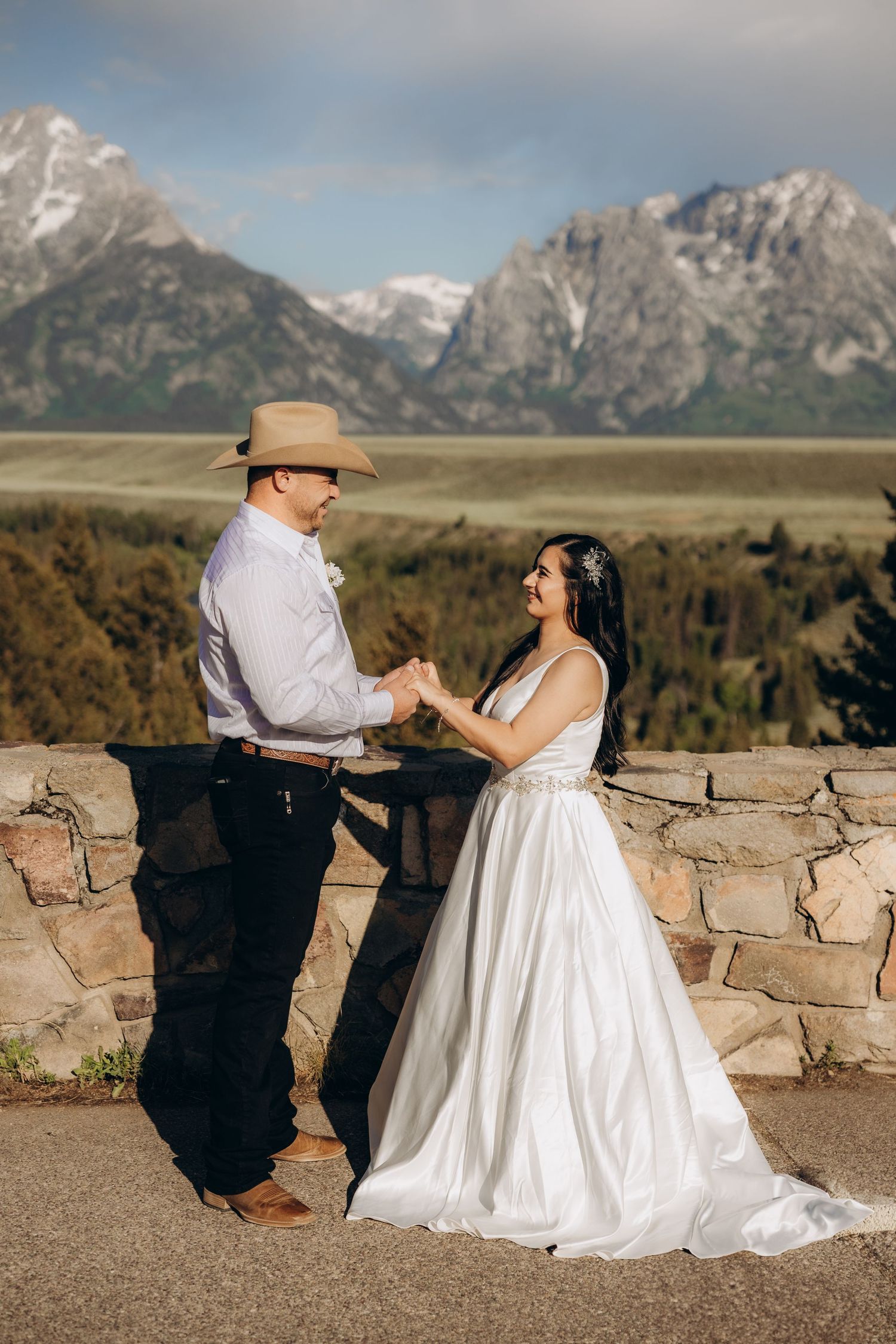 A couple sharing a special moment against the backdrop of majestic snow-capped mountains in Grand Teton National Park.