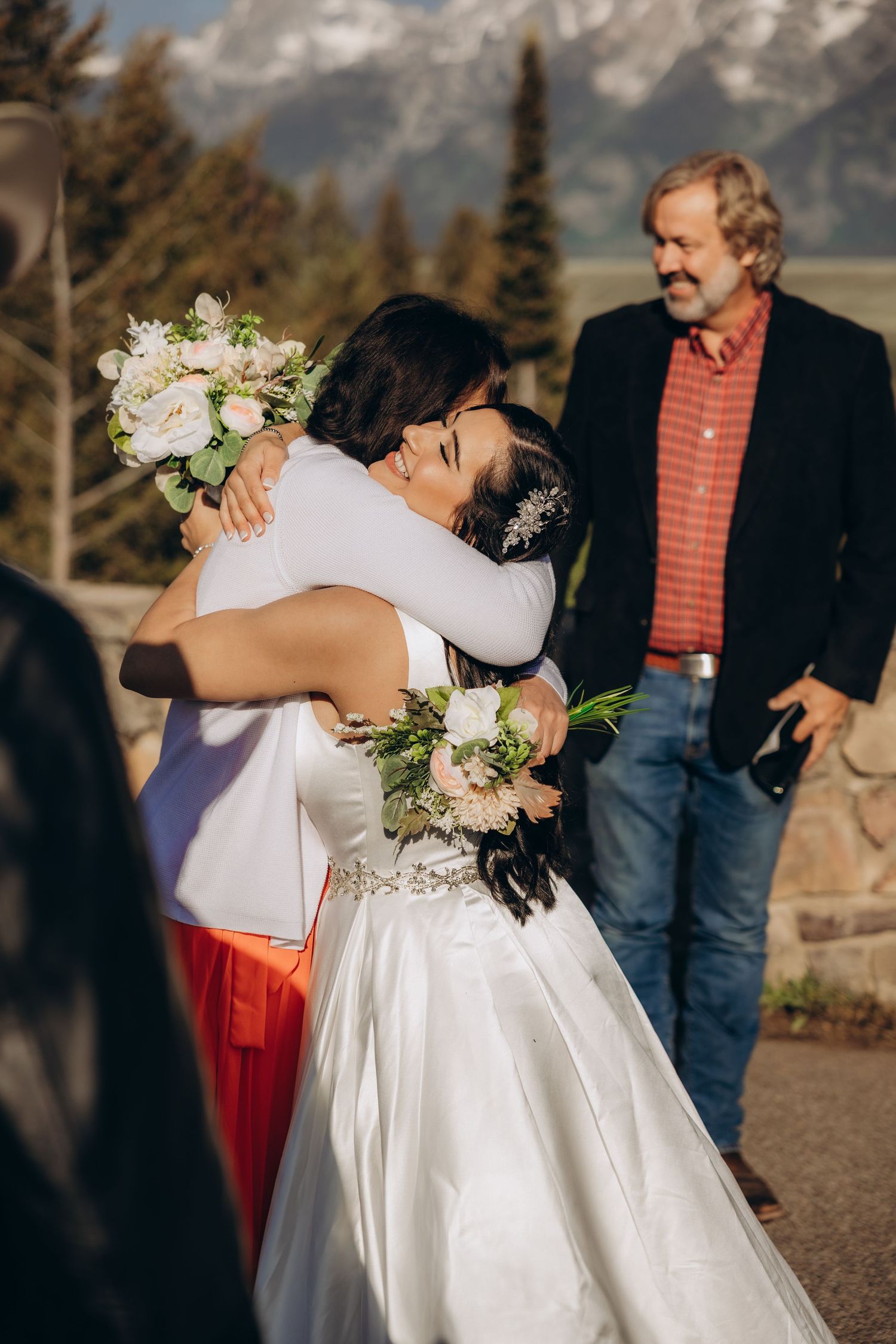 A sequence of wedding photos capturing an emotional embrace between two people during a mountain ceremony.