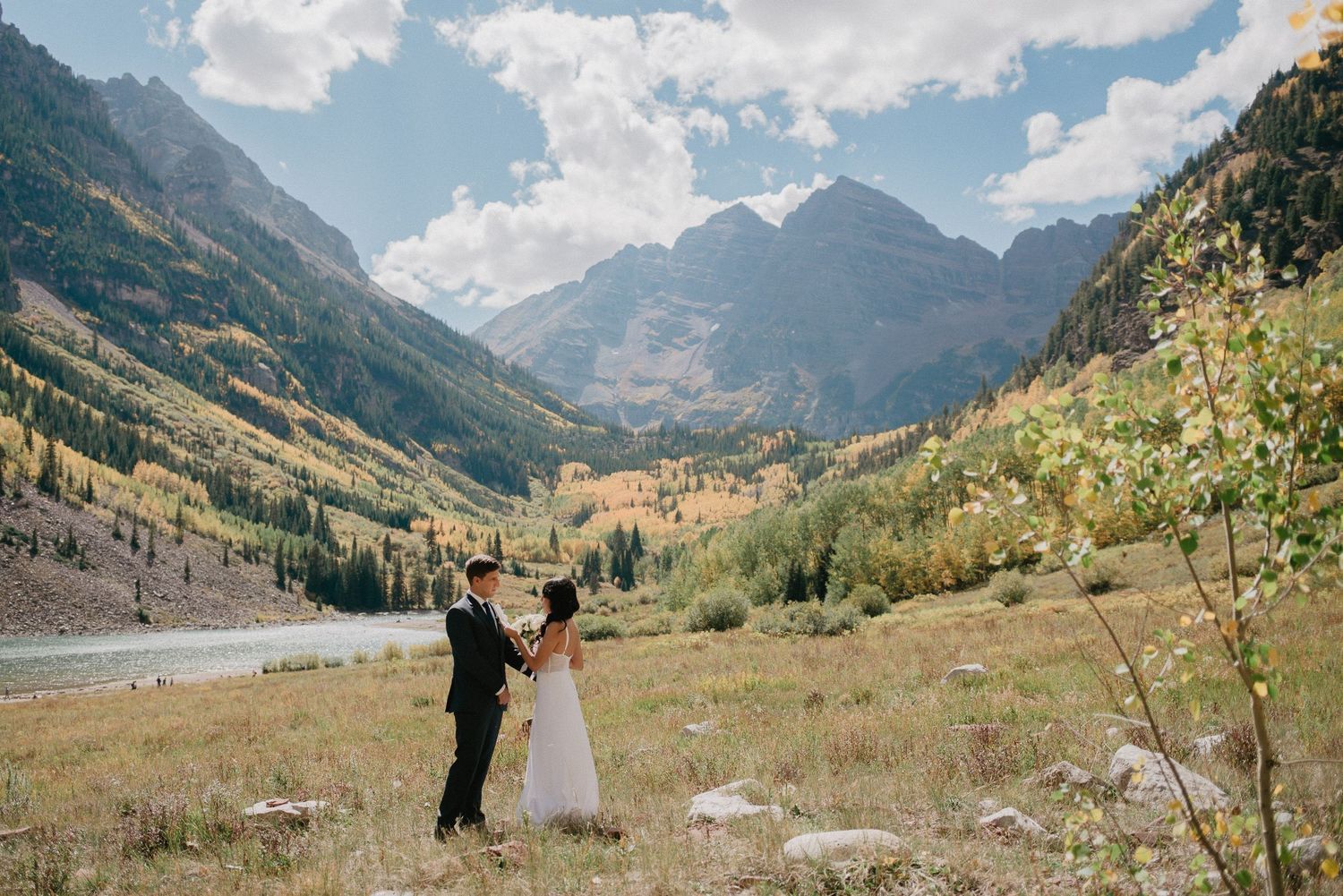 A couple exchanging vows during their elopement at Maroon Bells in Aspen, Colorado. Aspen elopement photography for non-hiking couples.