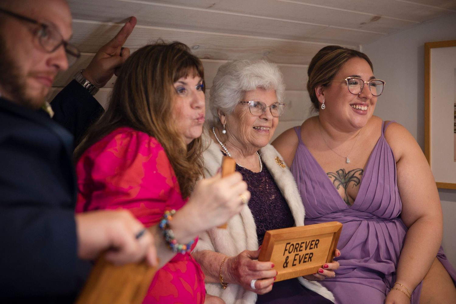 Wedding guests react joyfully while watching a special moment during the reception ceremony.