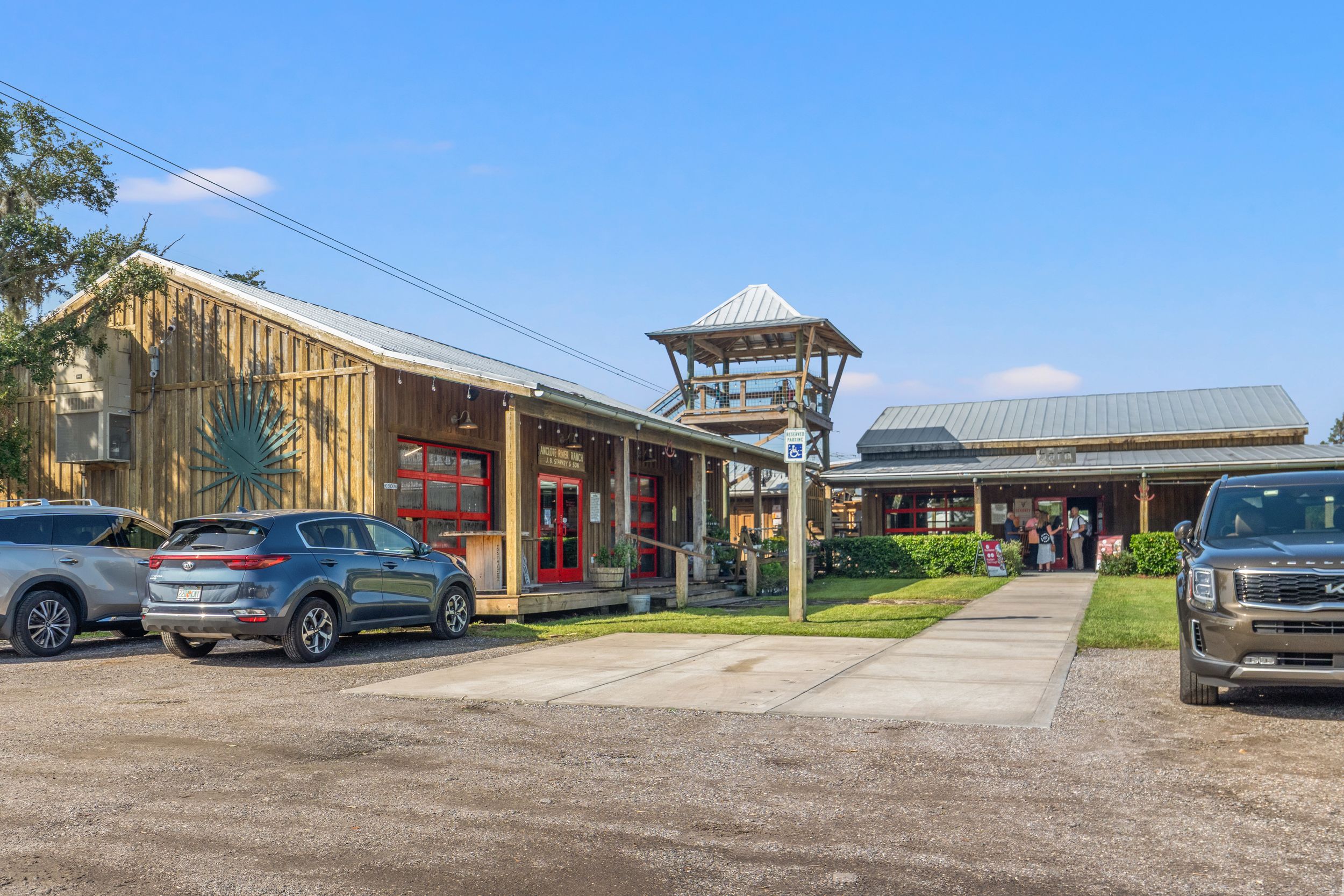Rural building complex with parking lot and multiple structures visible.