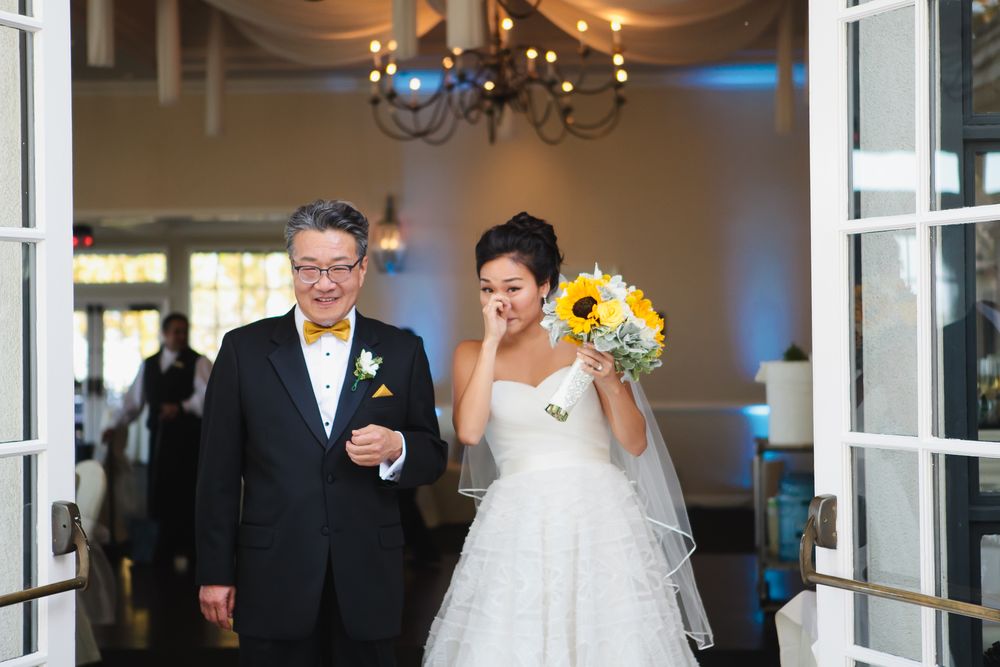 Elegant indoor wedding venue with chandelier and French doors.