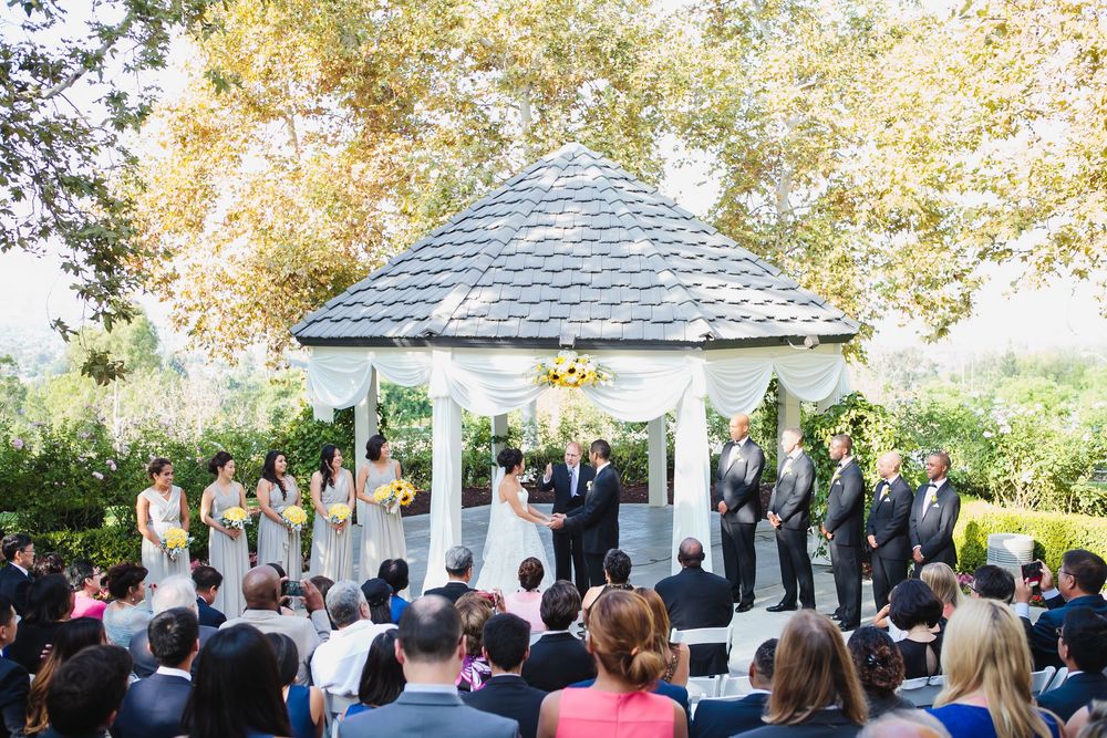 Outdoor wedding ceremony at Summit House under white gazebo with guests seated on lawn.