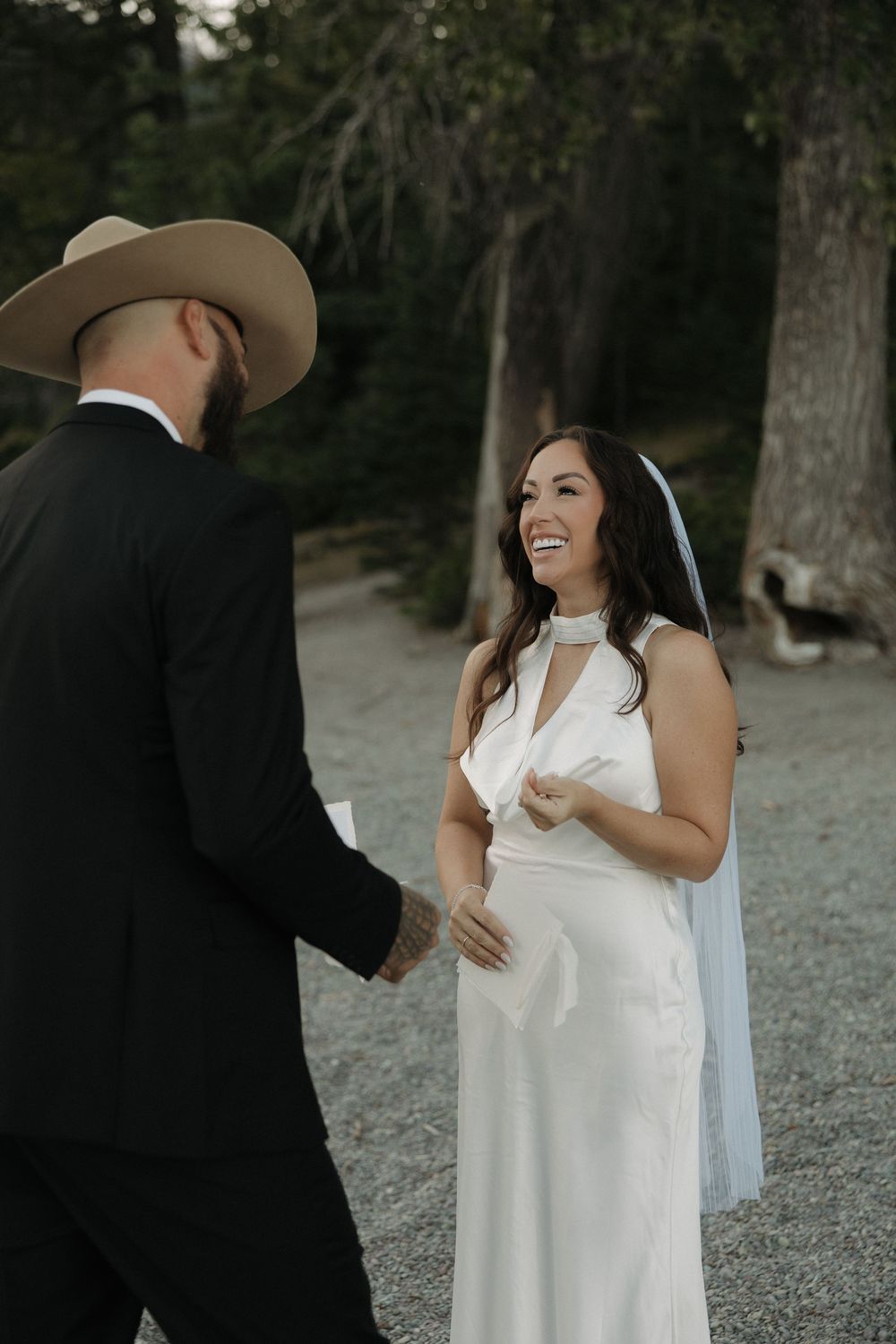 A couple sharing an intimate moment during their lakeside wedding celebration.