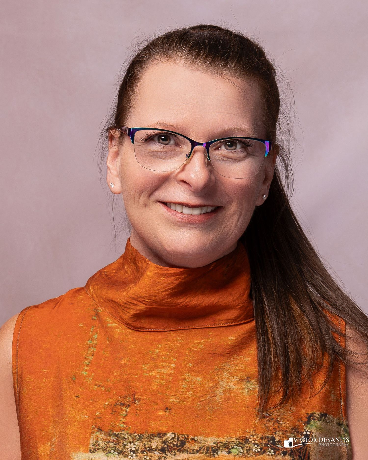Series of headshots featuring a bright orange turtleneck sweater and glasses against a mauve background.